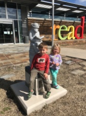 Liam and Cora Jean posing outside the H. Clinton Children's Library